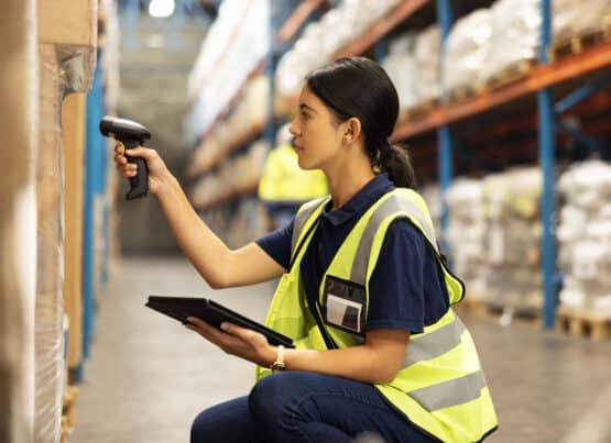 Woman scanning barcode in distribution warehouse