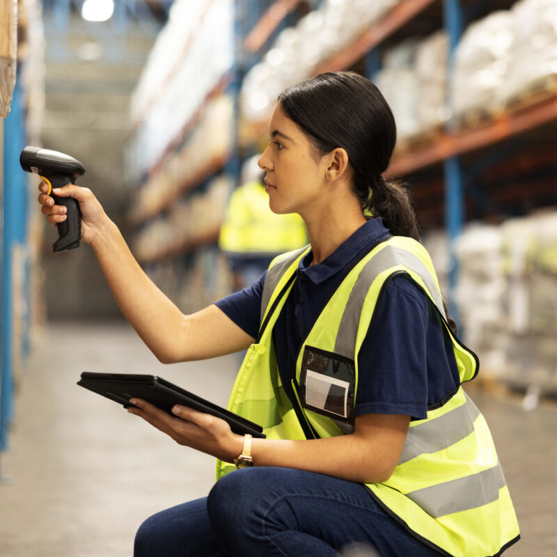 Woman scanning barcode in distribution warehouse